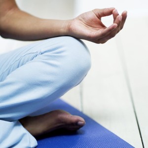 Young Woman Meditating on the Floor