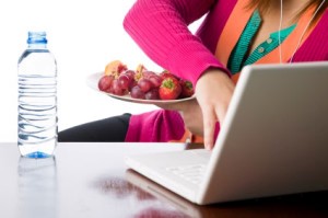 Woman having a fruit lunch at her desk