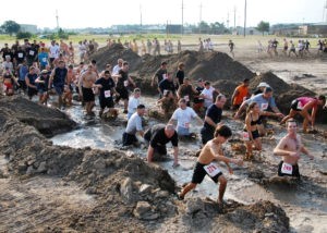 100918-N-7084M-233 GULFPORT, Miss. (Sept. 18, 2010) Participants in the 15th annual Seabee Volkslauf Mud Run trudge through one of the first obstacles of the five-mile course at Naval Construction Battalion Center. More than 1,000 people participated in this yearÕs mud run, raising more than $27,000 to help fund the 2011 Seabee Ball. (U.S. Navy photo by Equipment Operator 3rd Class Mikayla Mondragon/Released)